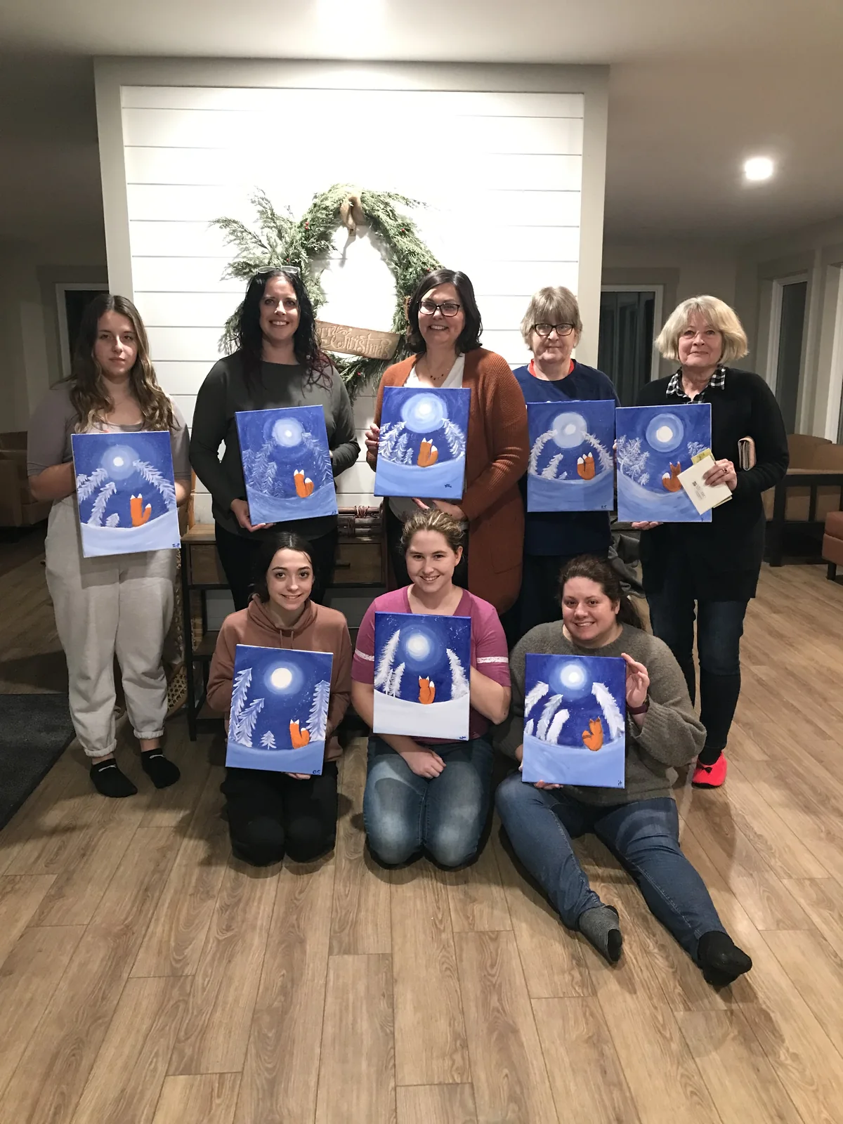 Friends at a paint party with the paintings they made